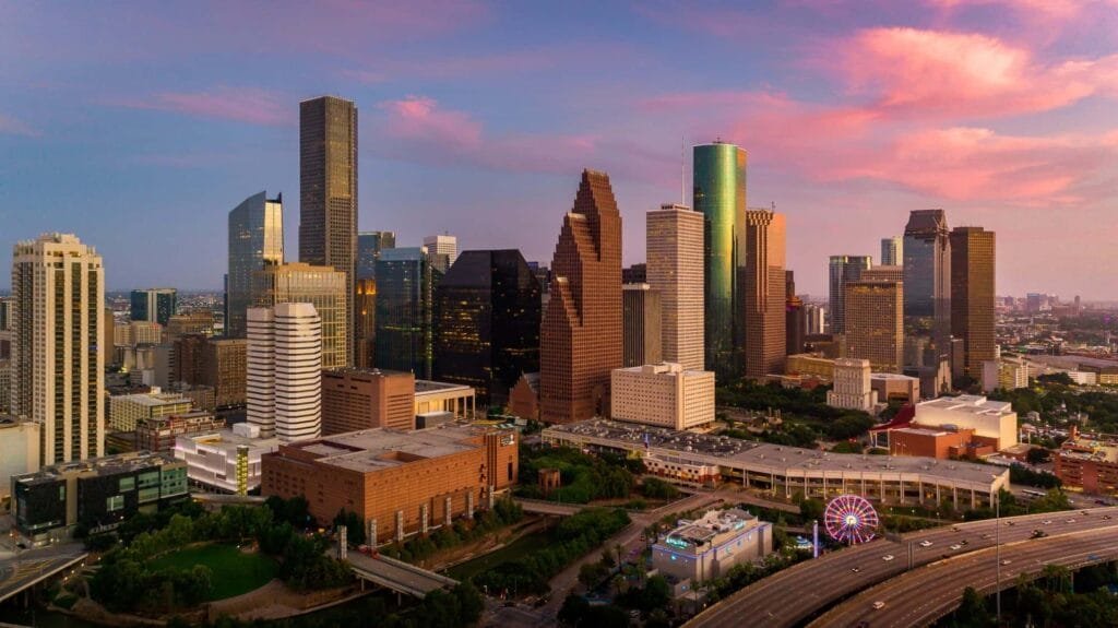 Houston, Texas skyline at sunset, showcasing its vibrant cityscape as well as the stunning hues of the evening sky.