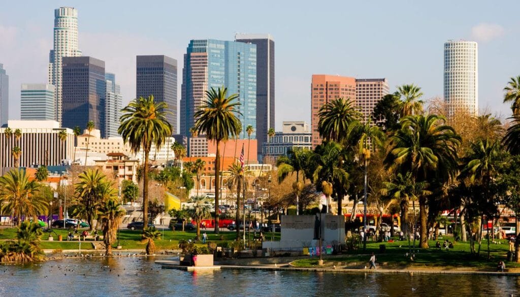 Los Angeles skyline with palm trees in the background, showcasing an iconic urban landscape.