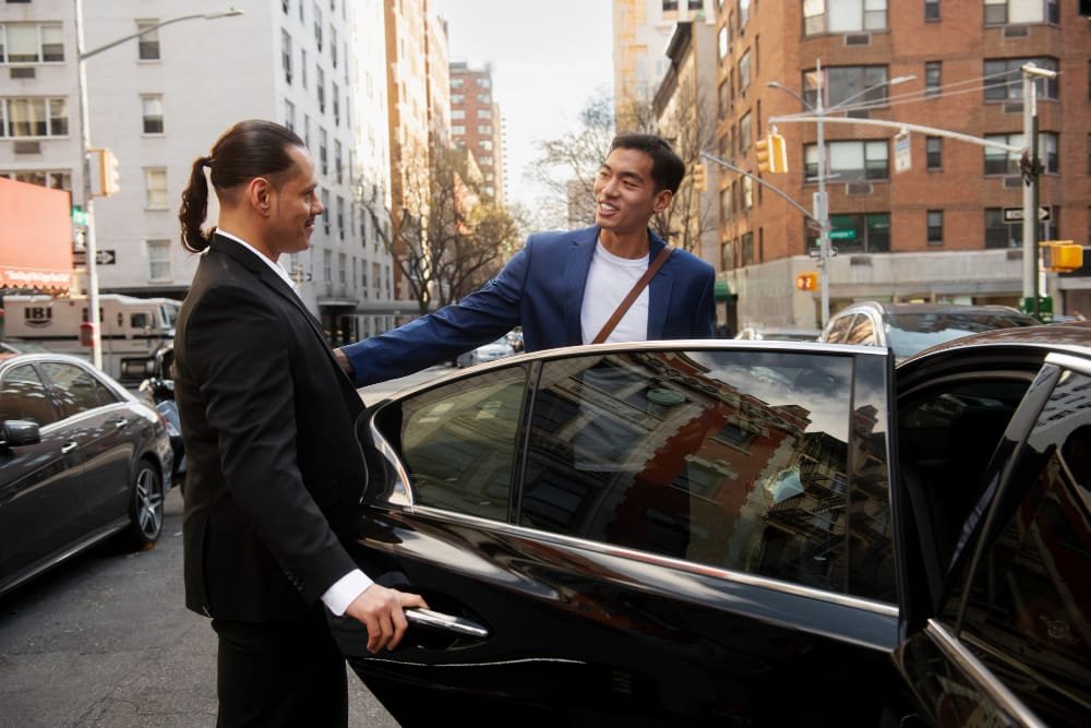 Two men arriving at the airport in NYC using a limo service.