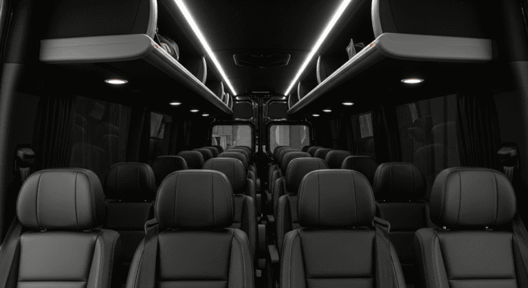 Interior of a luxury coach with leather seats and soft ambient lighting.